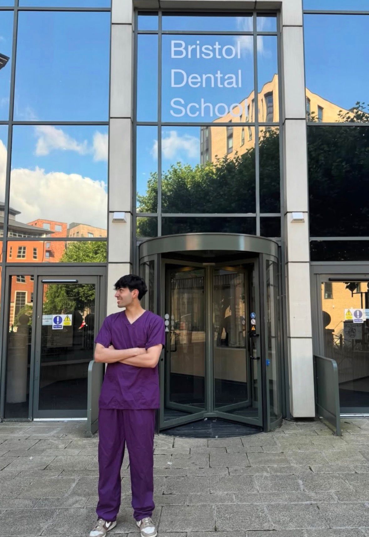 Zain standing outside Bristol Dental School